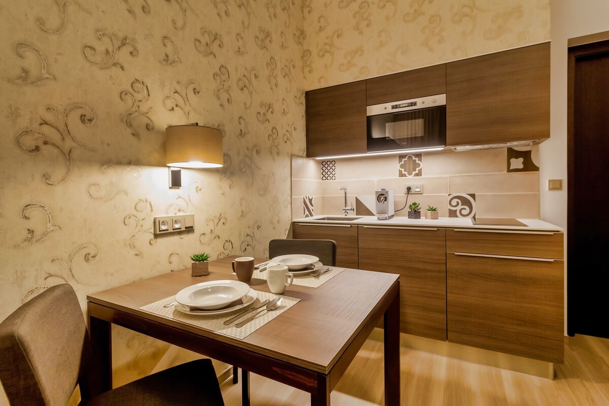 Elegantly set dining table in a well-appointed kitchenette at Aparthotel Vinohradsky Dum in Prague.