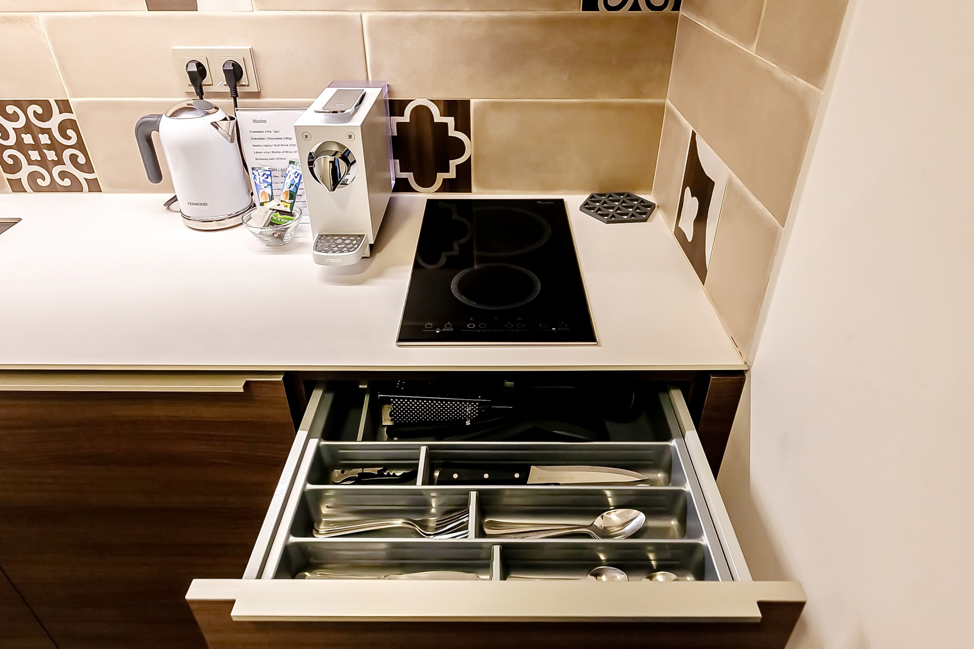 Fully equipped kitchen with sink, microwave, and toaster at Aparthotel Vinohradský dům Prague Studio Deluxe Suite.