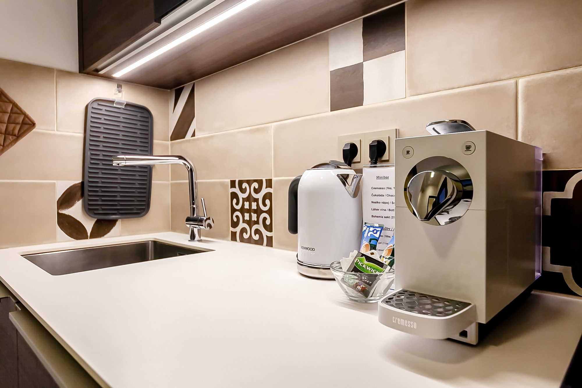 Fully equipped kitchen with sink, microwave, coffe maker, and toaster at Aparthotel Vinohradský dům Prague. Gallery.